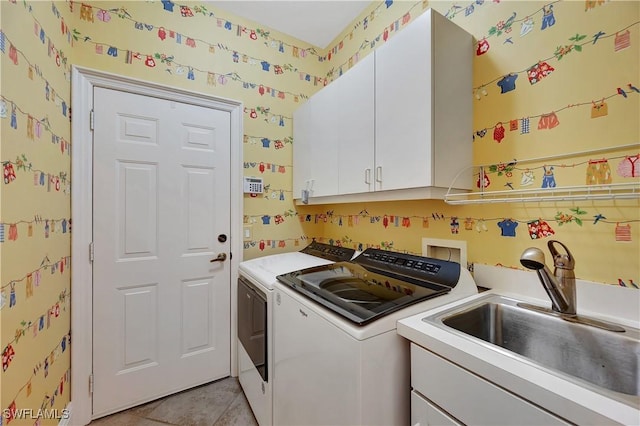 clothes washing area featuring washer and clothes dryer, light tile patterned floors, cabinet space, a sink, and wallpapered walls