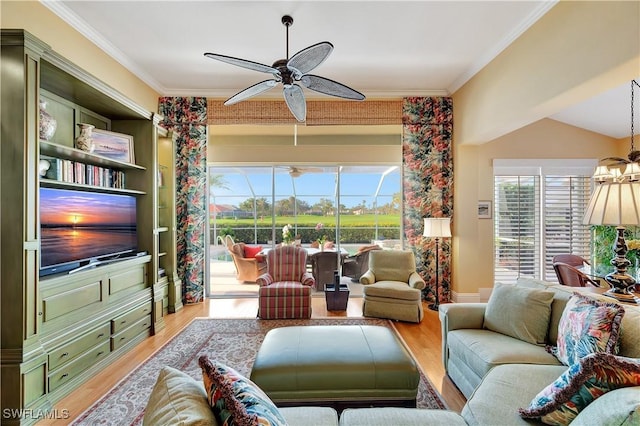 living room with light wood-style floors, plenty of natural light, crown molding, and ceiling fan with notable chandelier