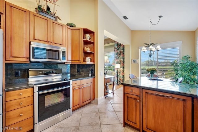 kitchen with dark countertops, appliances with stainless steel finishes, and open shelves