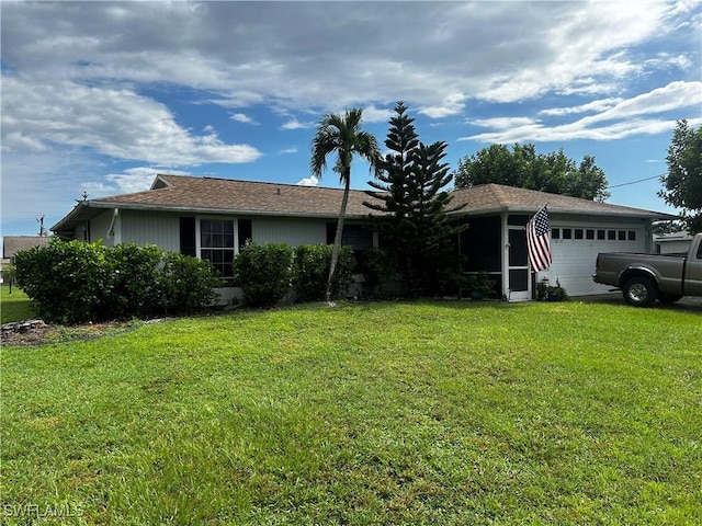 single story home featuring a garage and a front lawn