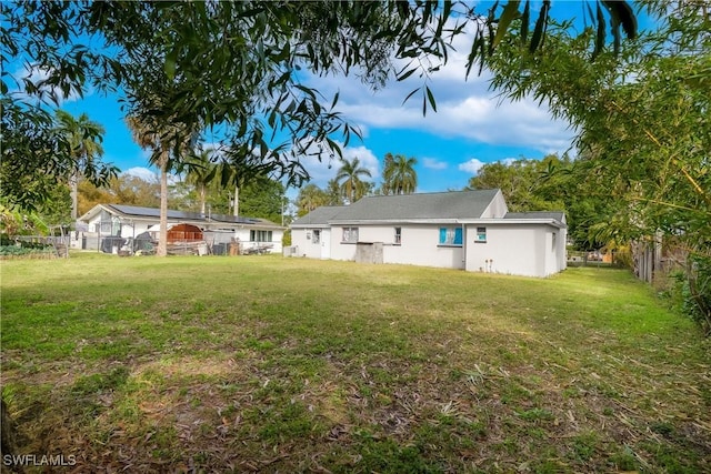 rear view of property with a yard