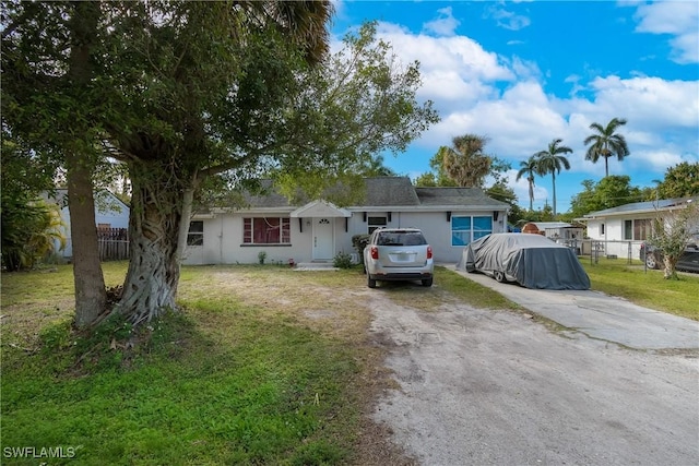 ranch-style home with a front lawn