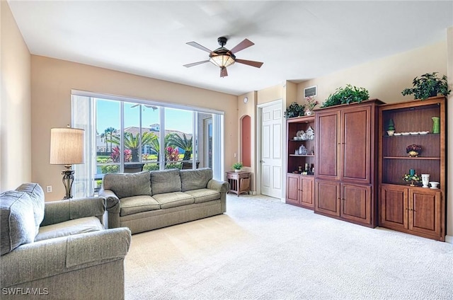 living room with light carpet and ceiling fan