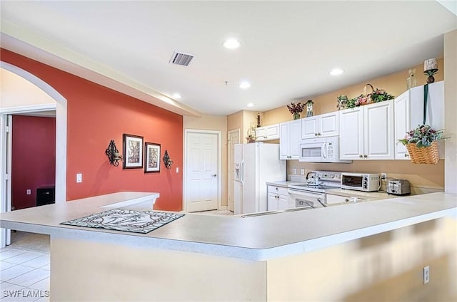 kitchen with white cabinetry, white appliances, kitchen peninsula, and light tile patterned flooring