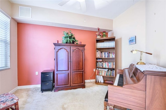 sitting room featuring light carpet and ceiling fan