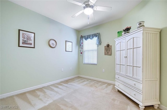 unfurnished bedroom featuring light carpet and ceiling fan