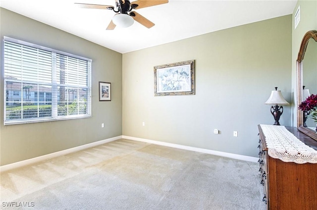 unfurnished room with light carpet and ceiling fan