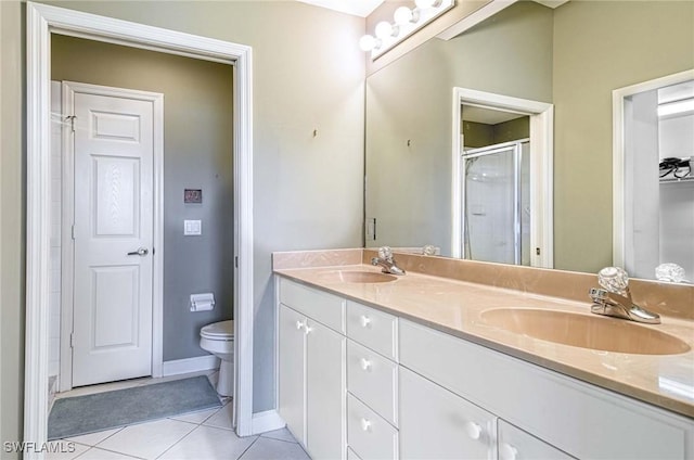 bathroom with tile patterned floors, toilet, a shower with shower door, and vanity