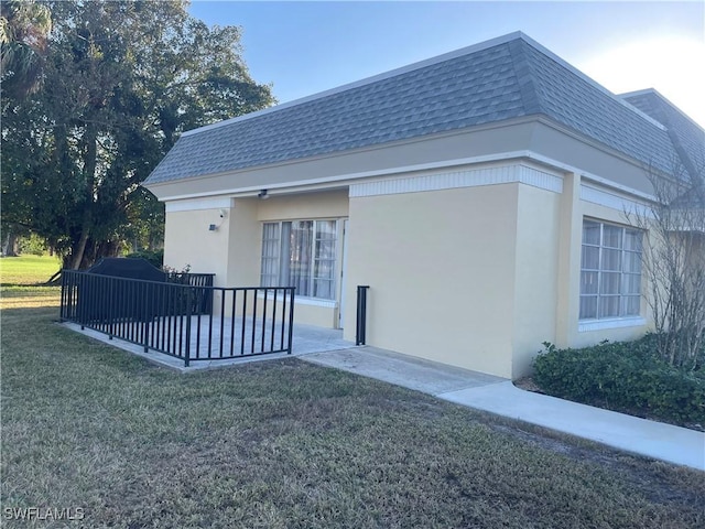 view of side of property with a yard