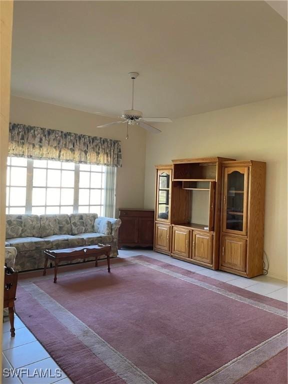 tiled living room featuring ceiling fan