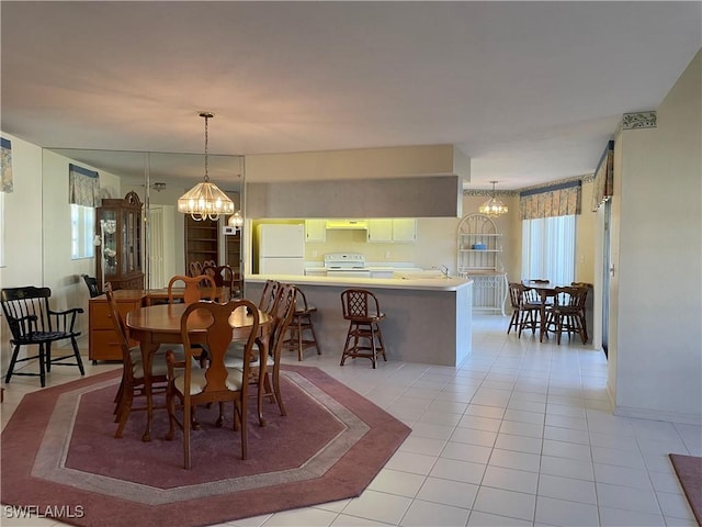 dining room featuring light tile patterned floors and a notable chandelier