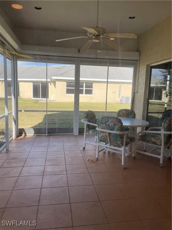 sunroom / solarium featuring ceiling fan and a healthy amount of sunlight