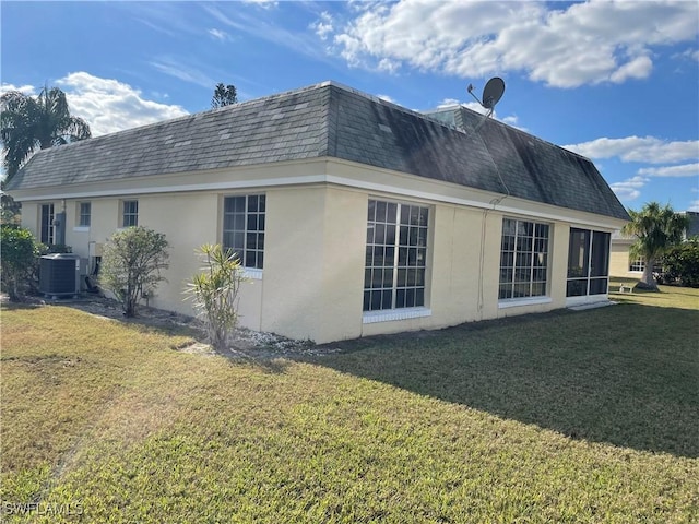 view of side of property with cooling unit and a lawn