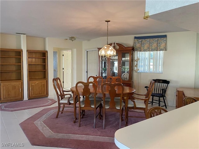 dining space featuring a chandelier and light tile patterned flooring