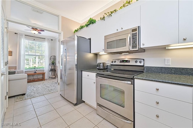 kitchen featuring light tile patterned floors, crown molding, ceiling fan, white cabinetry, and stainless steel appliances