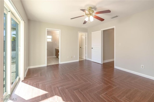 empty room featuring dark parquet flooring and ceiling fan