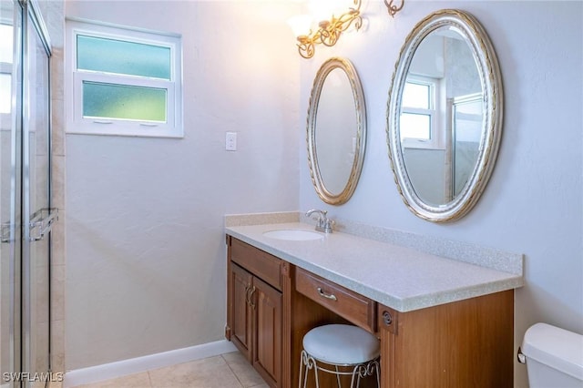 bathroom featuring tile patterned flooring, vanity, and toilet