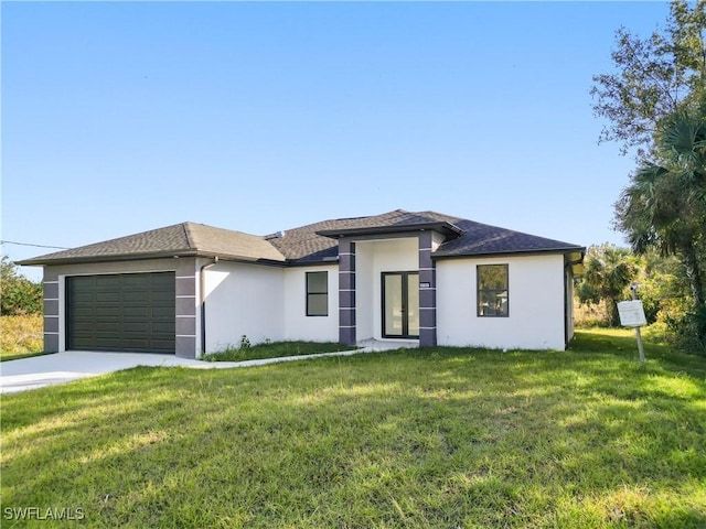 view of front of home with a garage and a front yard