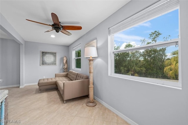 sitting room featuring ceiling fan and light tile patterned flooring