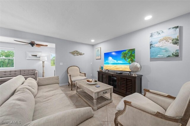 living room featuring ceiling fan and light tile patterned flooring