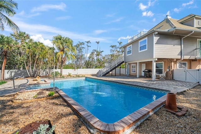 view of swimming pool with a grill and a patio area