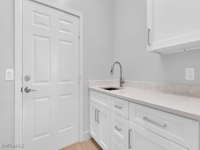 interior space with sink and light hardwood / wood-style flooring