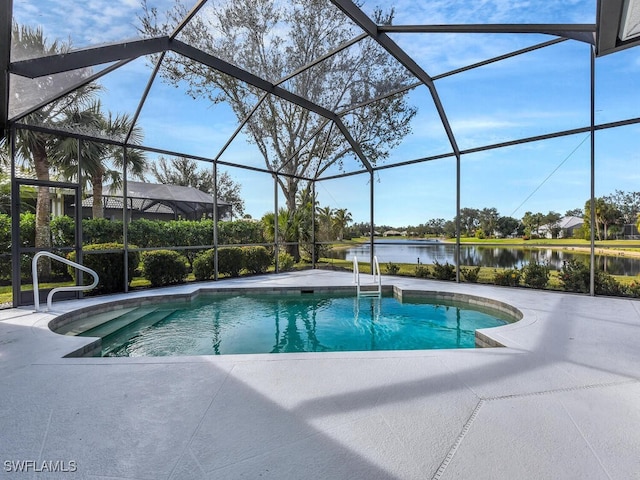 view of pool featuring a patio area, glass enclosure, and a water view