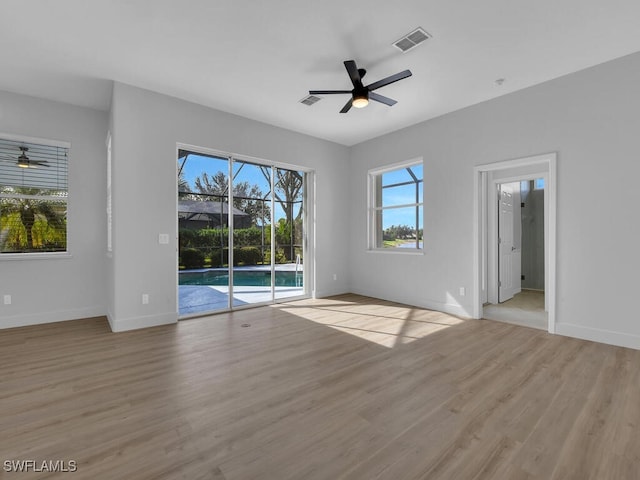 unfurnished room with ceiling fan and light hardwood / wood-style flooring