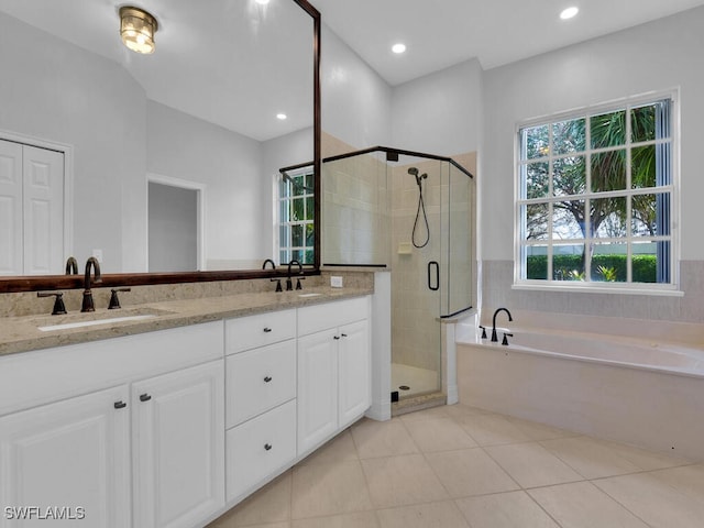 bathroom with tile patterned flooring, vanity, and shower with separate bathtub