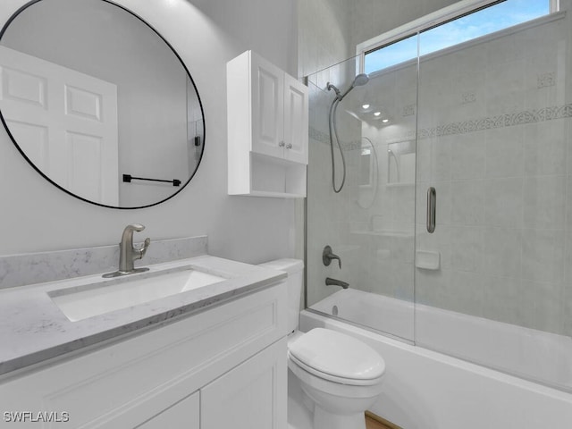 full bathroom with toilet, vanity, and shower / bath combination with glass door