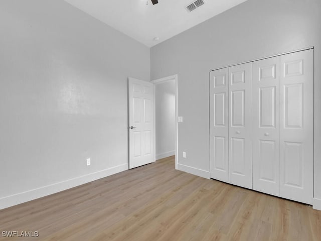 unfurnished bedroom with a closet, ceiling fan, and light hardwood / wood-style flooring