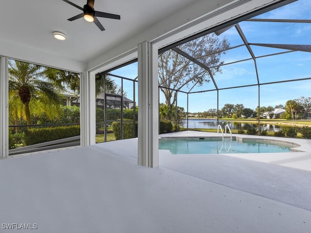 view of pool featuring a patio, a water view, and a lanai