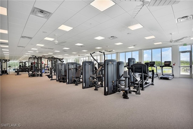 workout area with ceiling fan and a drop ceiling