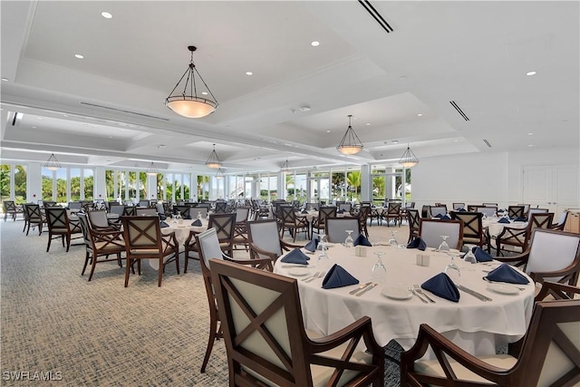 dining area featuring a raised ceiling and light carpet