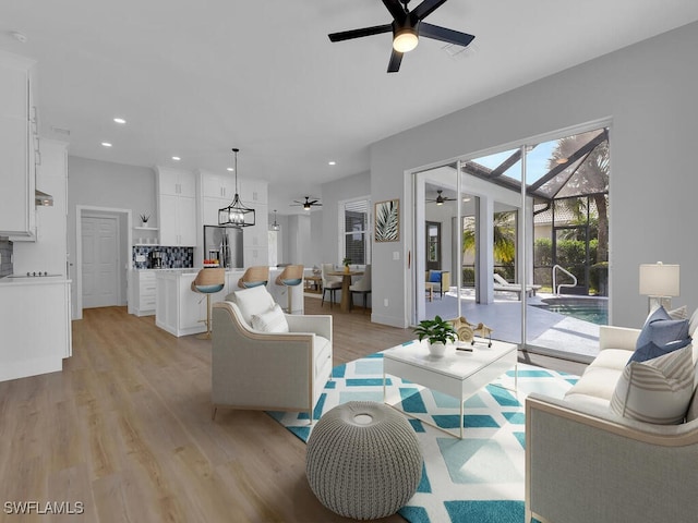 living room featuring ceiling fan and light wood-type flooring