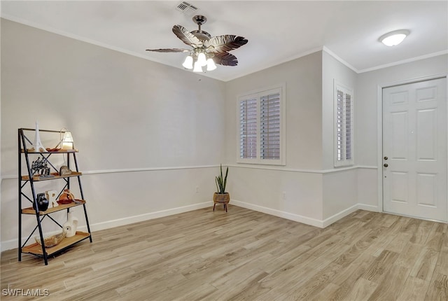 entrance foyer with crown molding, ceiling fan, and light hardwood / wood-style flooring