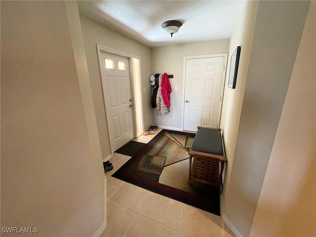 doorway to outside featuring light tile patterned floors