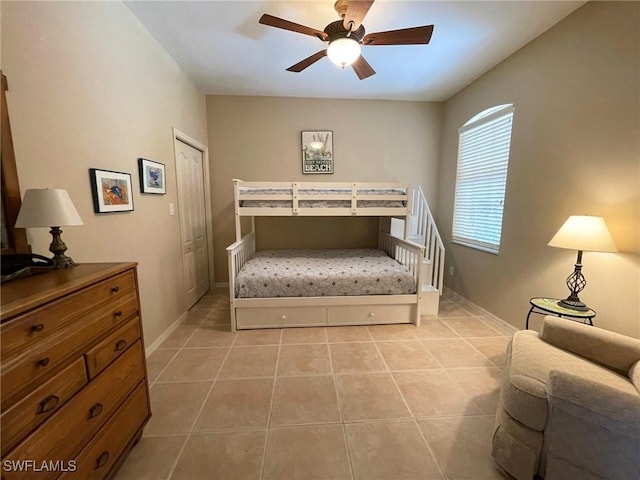 bedroom featuring light tile patterned floors and ceiling fan