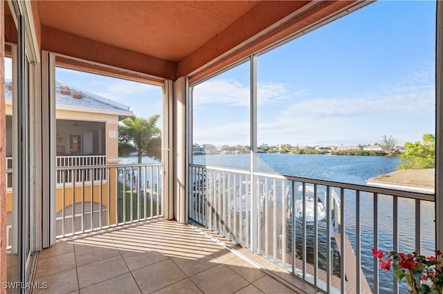 unfurnished sunroom featuring a water view