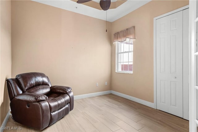 sitting room featuring ceiling fan and light hardwood / wood-style flooring