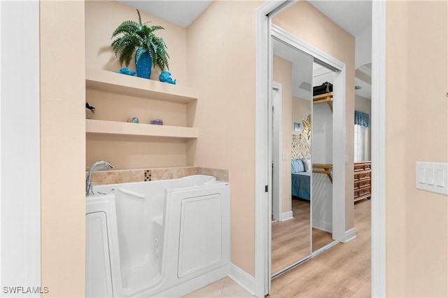 washroom featuring washer and dryer and light hardwood / wood-style flooring