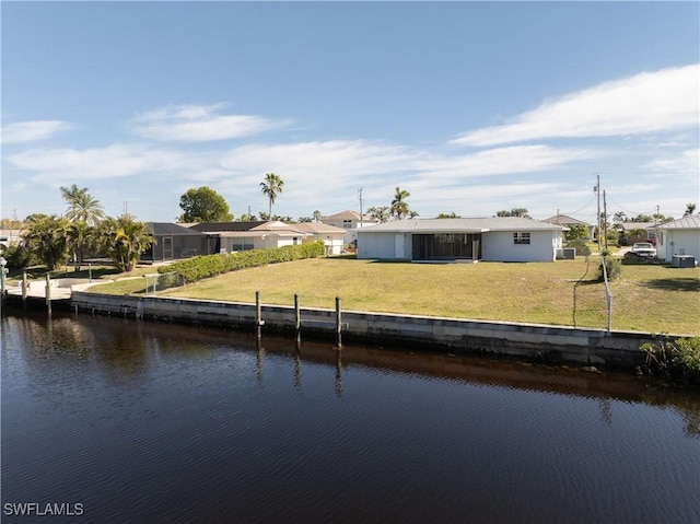 dock area featuring a water view and a lawn