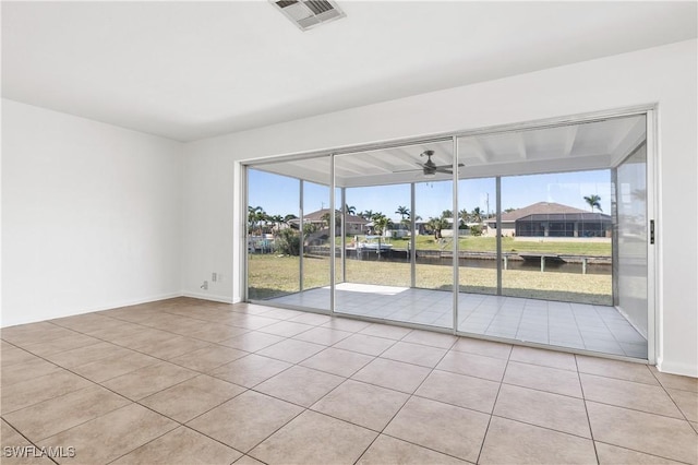 unfurnished room featuring ceiling fan and light tile patterned floors