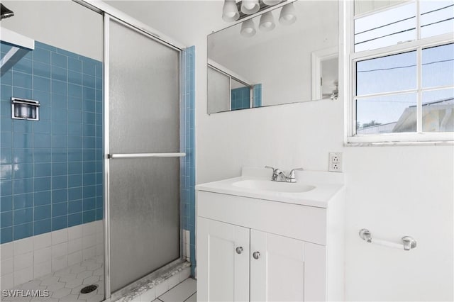 bathroom featuring vanity and a shower with shower door