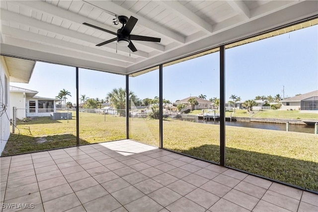 unfurnished sunroom featuring beamed ceiling, a water view, a wealth of natural light, and ceiling fan