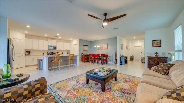 living room featuring light tile patterned flooring and ceiling fan