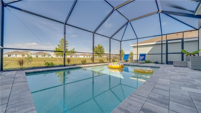 view of swimming pool with a patio and glass enclosure