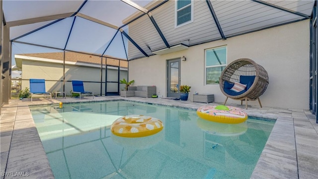 view of pool featuring a patio area and glass enclosure