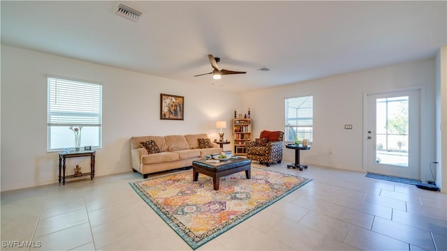 tiled living room with ceiling fan