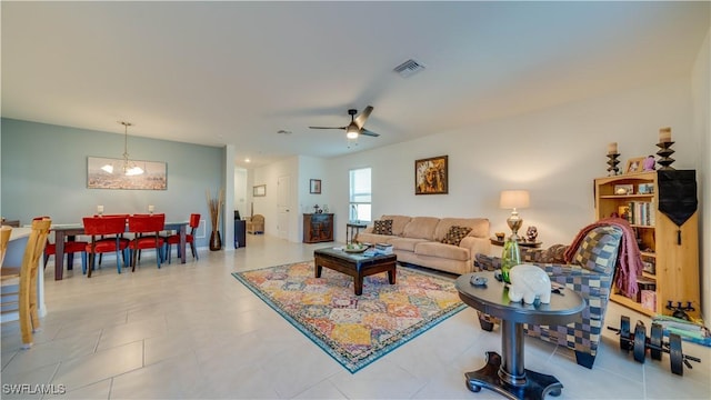 living room featuring ceiling fan with notable chandelier